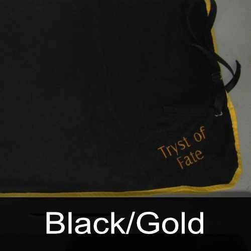 A black blanket with the words tryst of fate embroidered on it