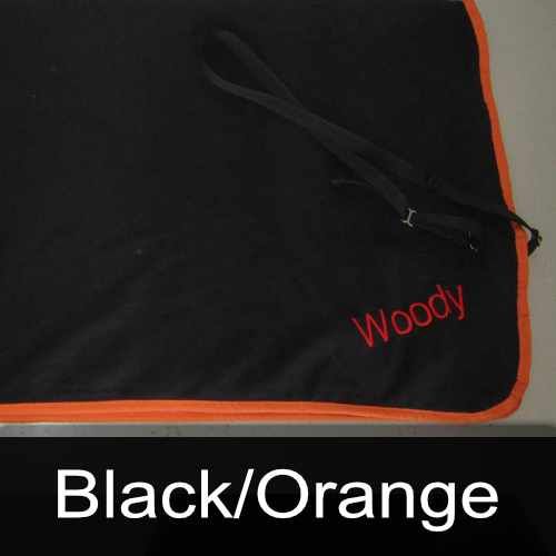 A black blanket with the name woody embroidered on it