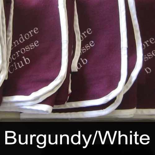 Burgundy and white shorts are stacked on top of each other
