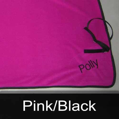 A pink blanket with the name polly embroidered on it