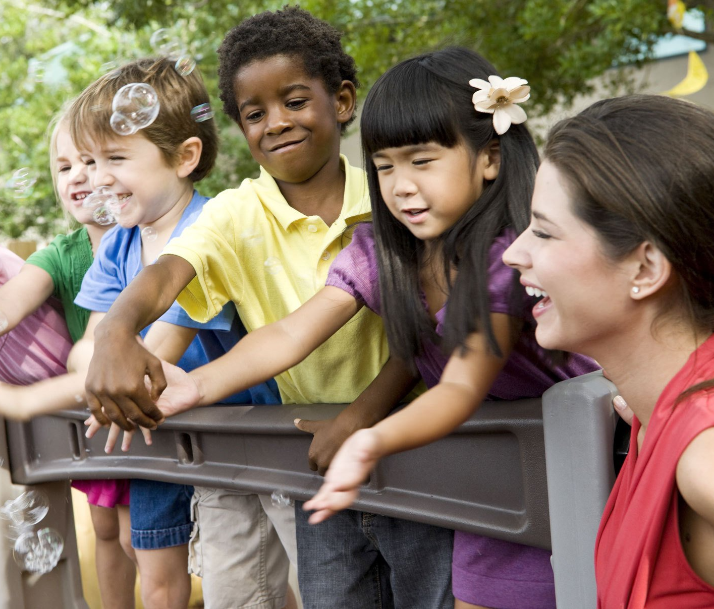 Preschool students smiling and playing