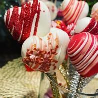 Red and white striped candy hearts on glittered sticks in a festive arrangement