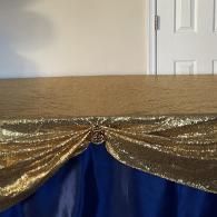 Gold and blue draped fabric over a stage or podium backdrop