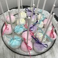 Pastel Easter eggs nestled in a white basket with tall white picket-like bars
