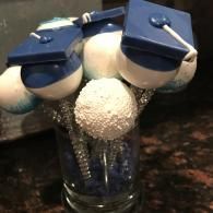 Three blue-and-white potion bottles with gold spoons, topped by textured white foam in a glass jar.