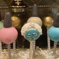 Colorful decorative lollipops with one blue face-shaped candy in the center