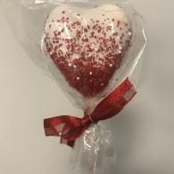 Heart-shaped red-and-white cake pop wrapped in clear plastic with a red ribbon bow