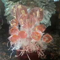 Pink-orange coral-like cluster with translucent petals and white strands against a dark background