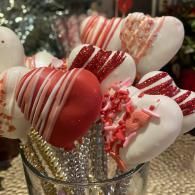 Heart-shaped red and white candy pops in a glass jar, festive and decorative