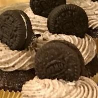 Chocolate cupcakes topped with swirled vanilla frosting and Oreo cookies