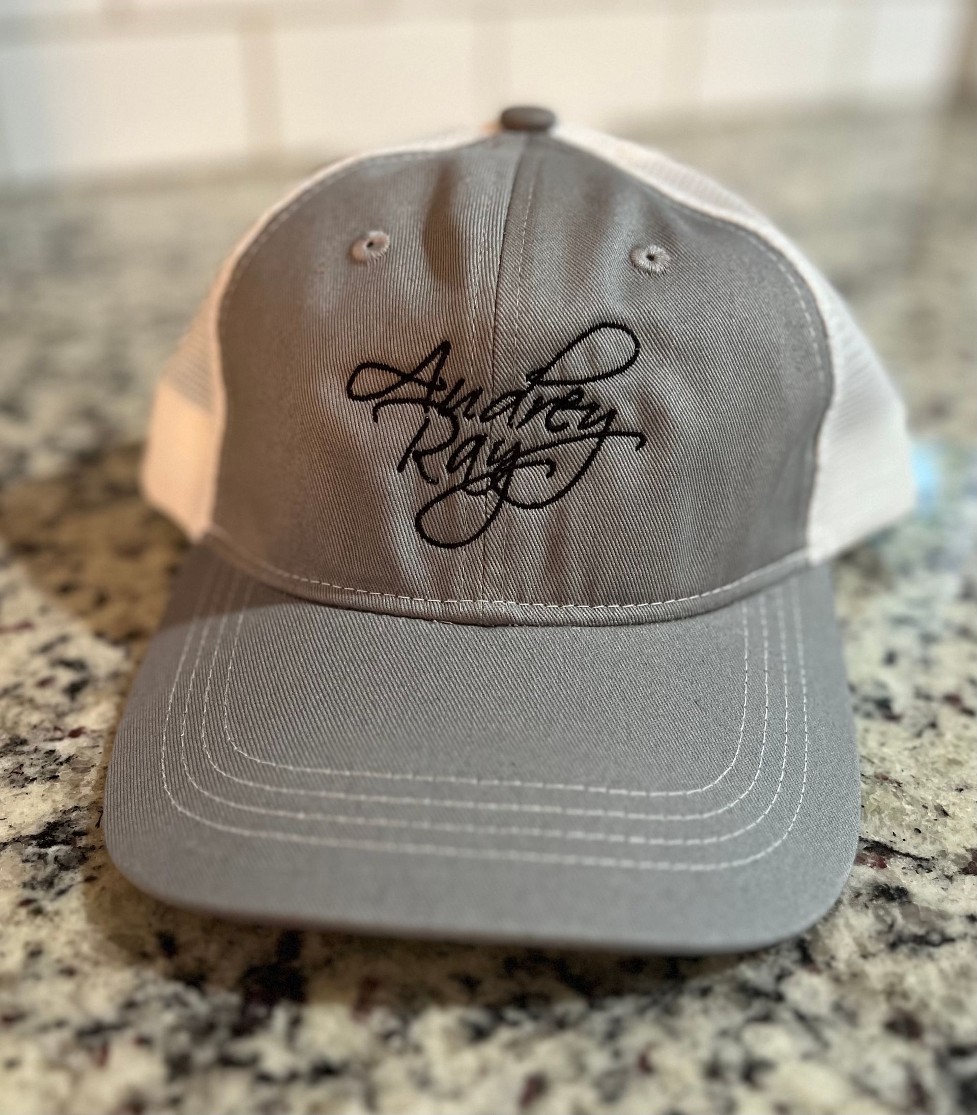 Light gray and white custom embroidered Audrey Ray hat. Only color available. One size fits all.