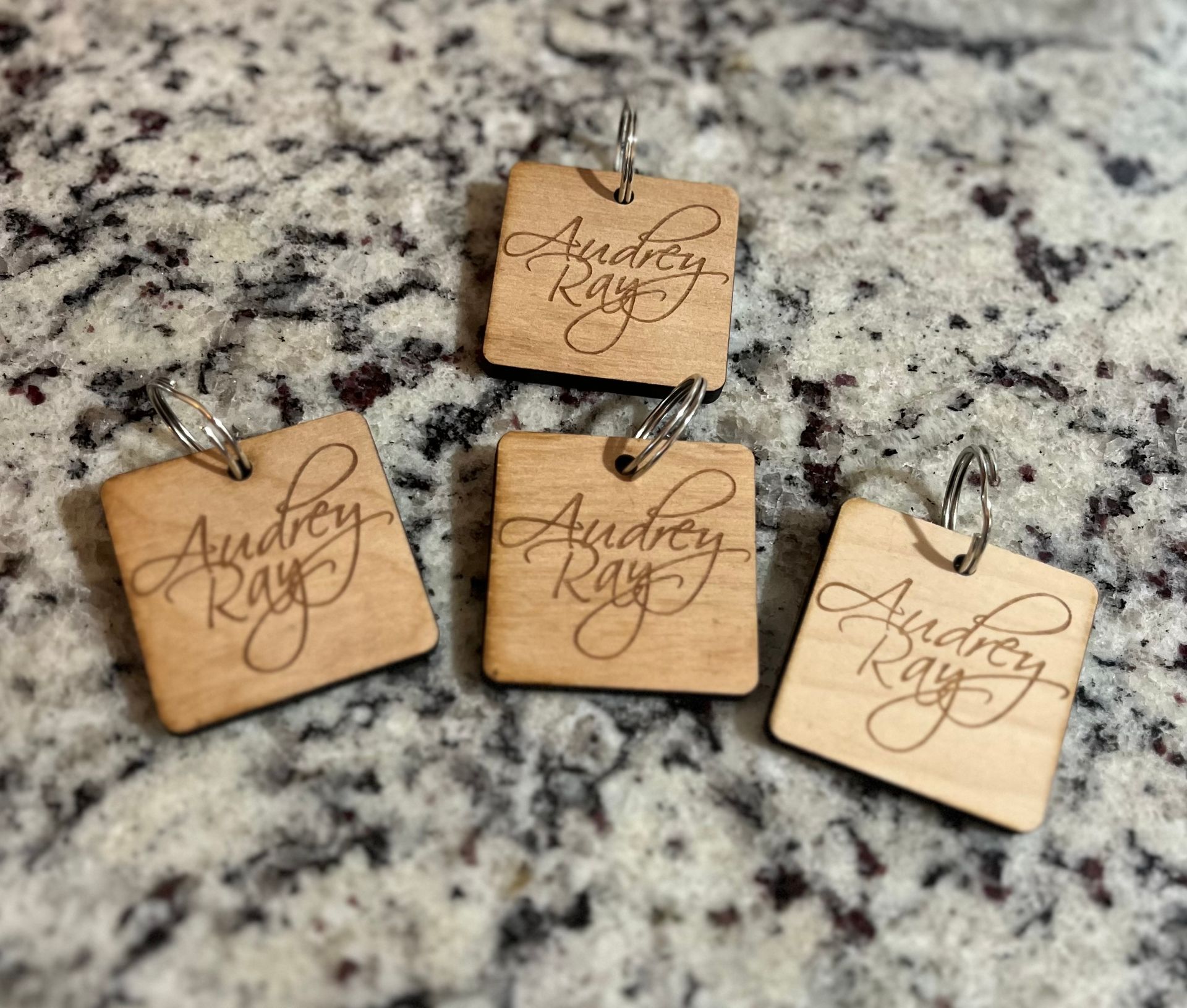 Custom wood etched Audrey Ray logo'd keychain. Front: Audrey Ray logo. Back: QR code links to Audrey Ray's Apple Music or Audrey Ray's Instagram.