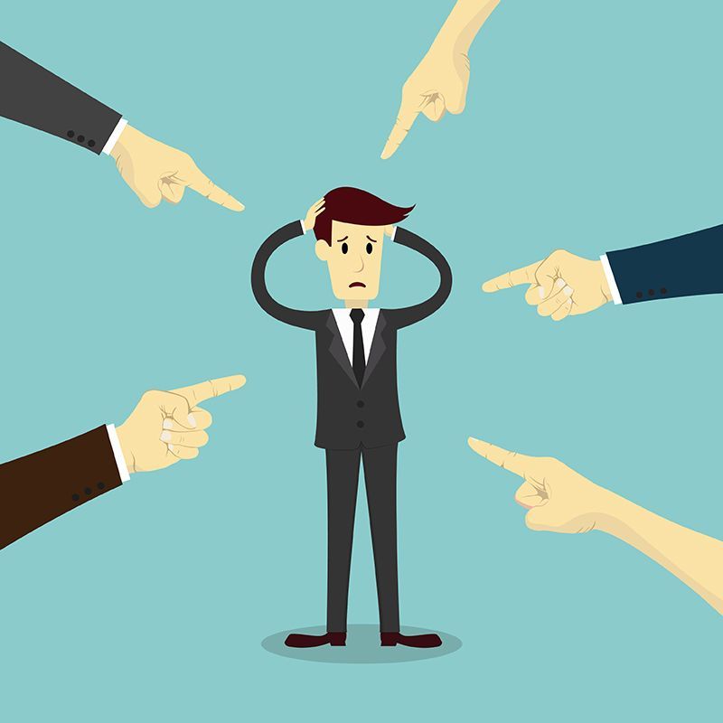 who's to blame?  people pointing fingers aa man in a suit