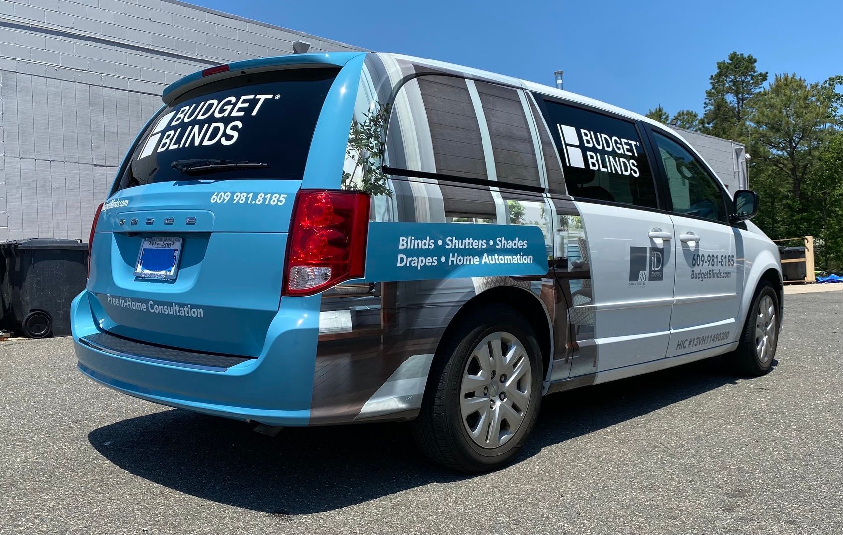 Blue and white branded van parked outdoors on a sunny day