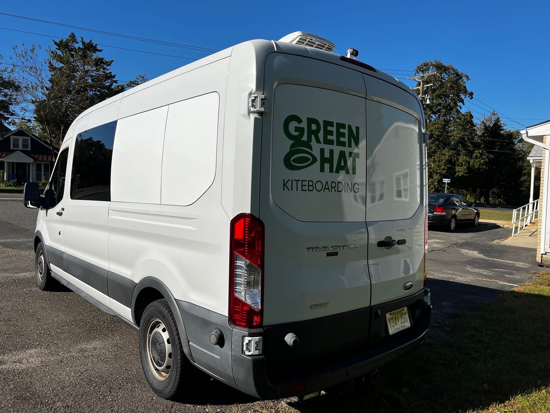 White Green Haul utility van parked outdoors on a sunny day