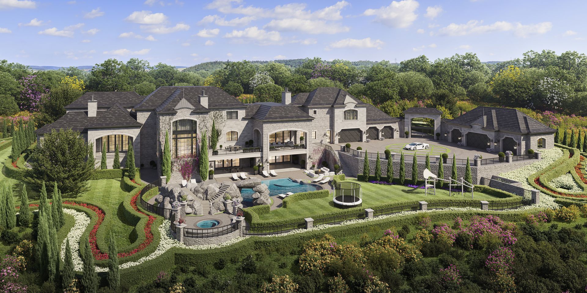 An aerial view of a large house on top of a hill surrounded by trees.