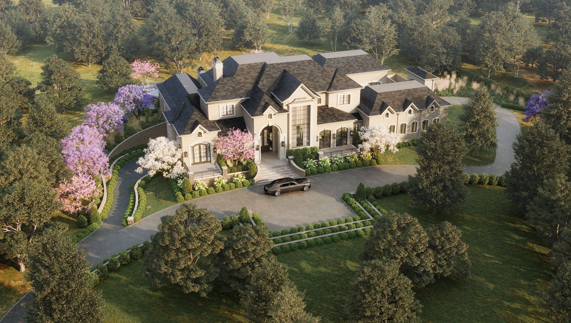 An aerial view of a large house with a car parked in front of it surrounded by trees.