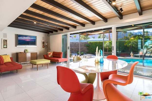 A living room with a dining table and chairs
