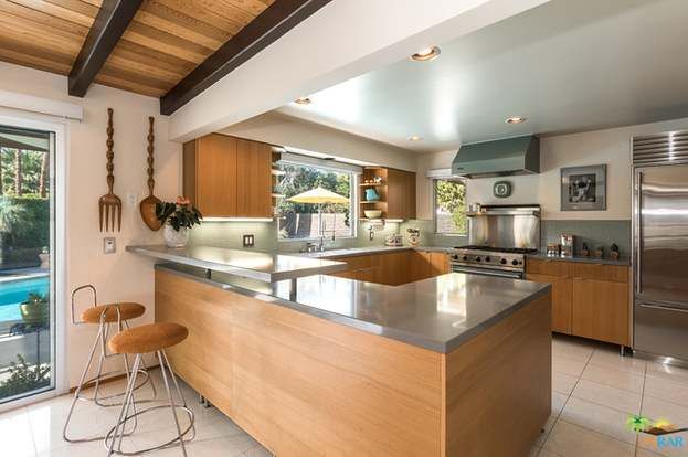 A kitchen with stainless steel appliances and wooden cabinets