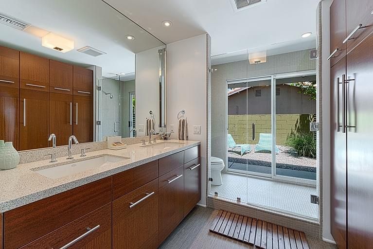 A bathroom with two sinks and a large mirror.