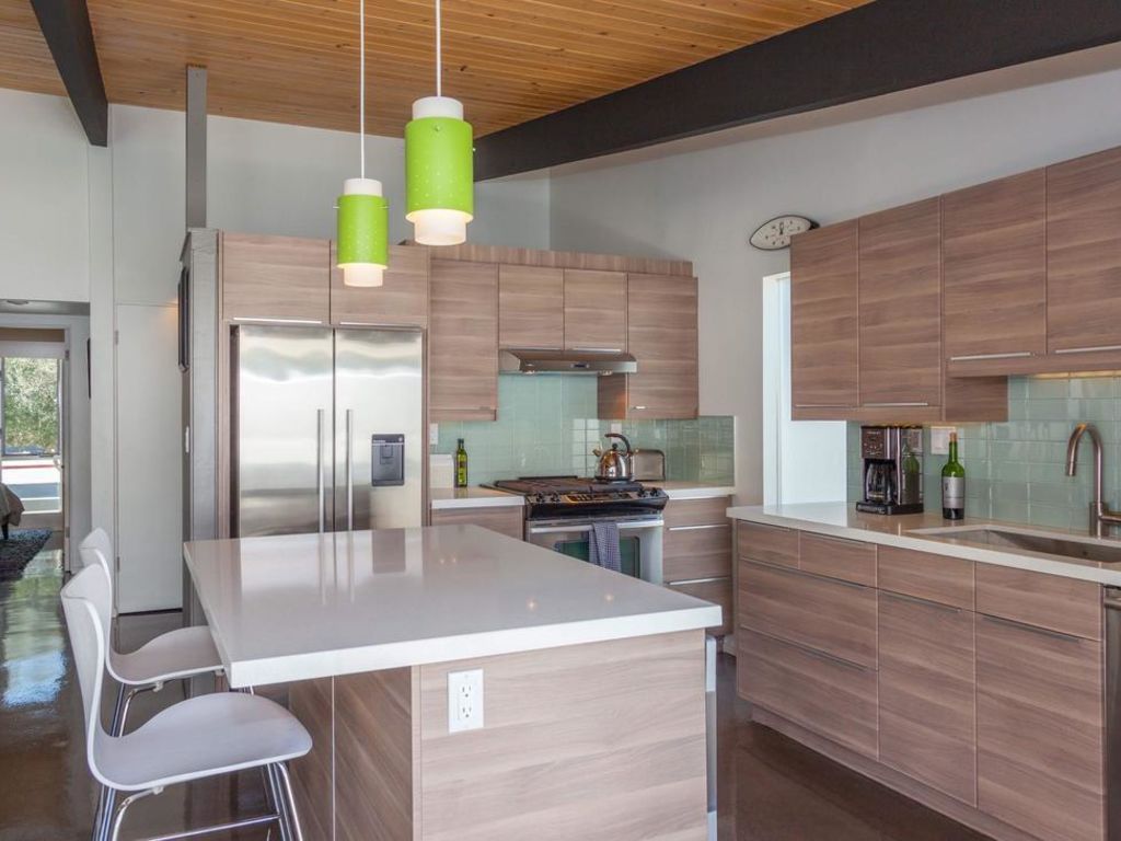A kitchen with wooden cabinets and stainless steel appliances