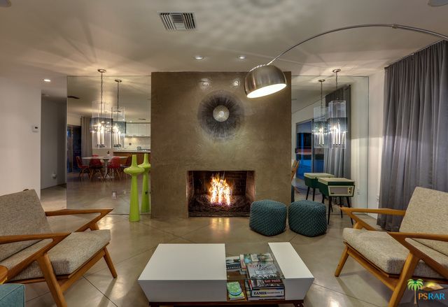 There is a fireplace in the middle of the living room.