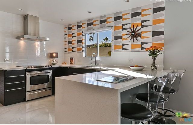 A kitchen with stainless steel appliances and a large island