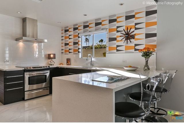 A kitchen with stainless steel appliances and a large island