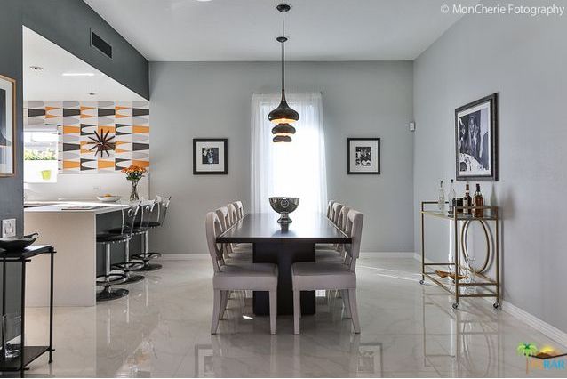 A dining room with a long table and chairs