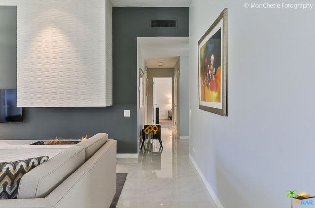 A living room with a couch and a painting on the wall