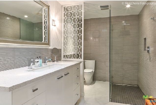 A bathroom with a toilet a sink and a walk in shower