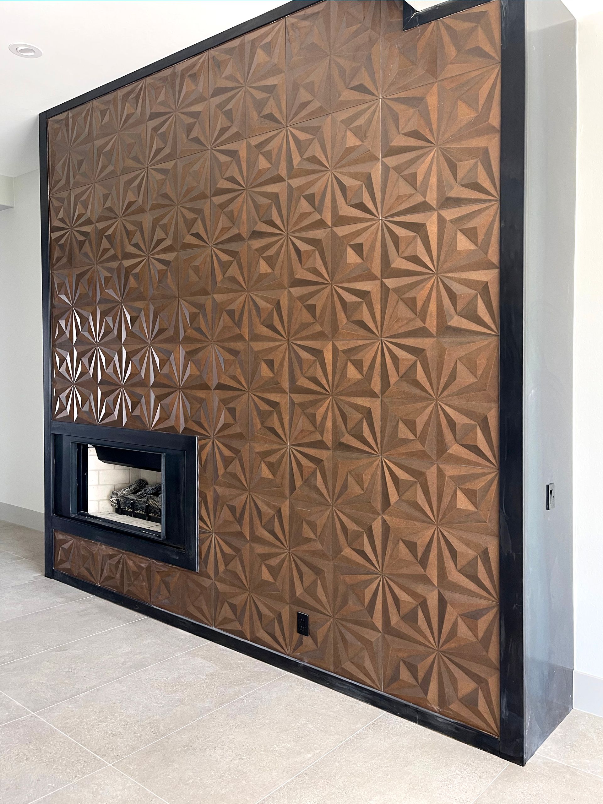 A living room with a fireplace and a wooden wall.