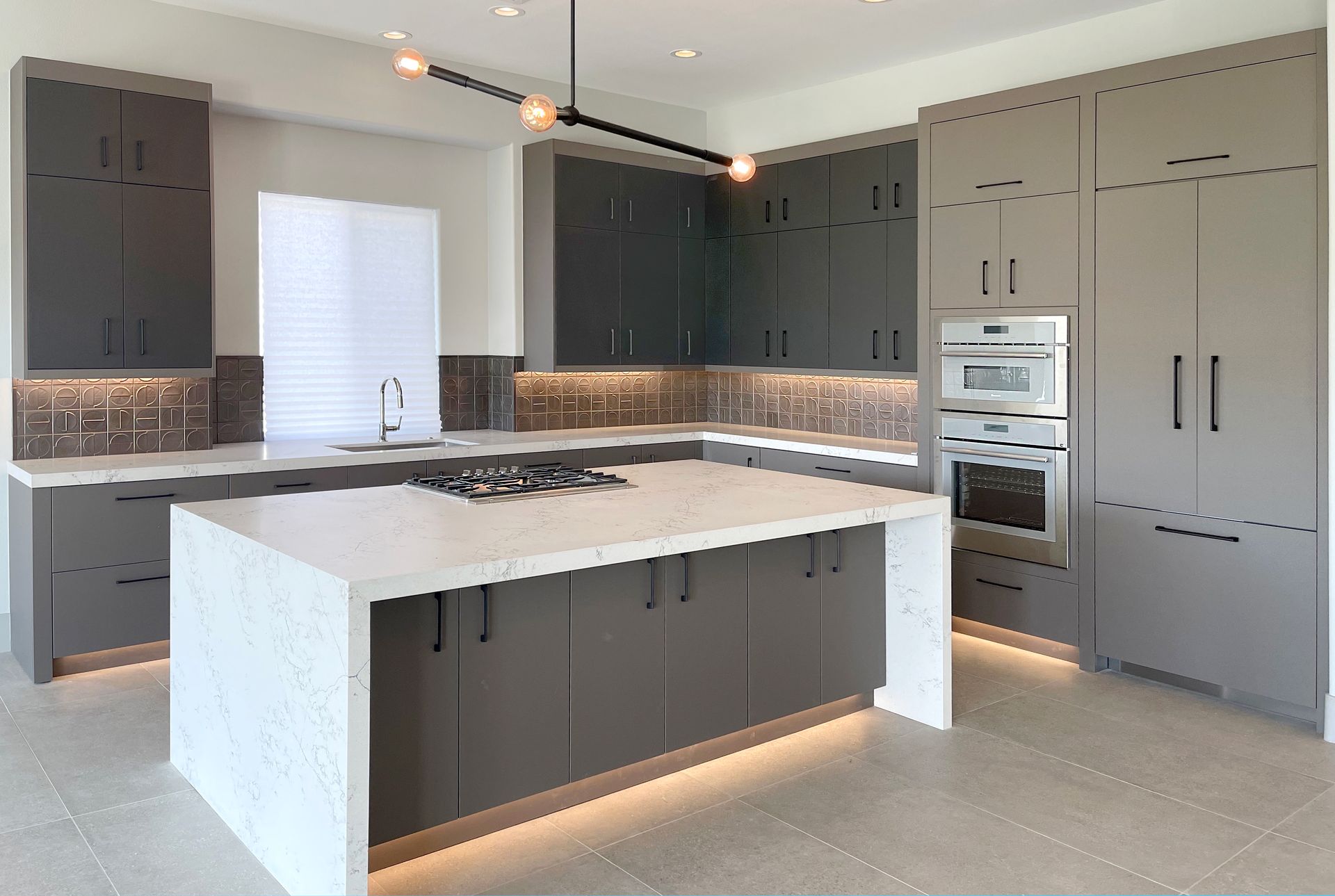 A kitchen with a large island in the middle