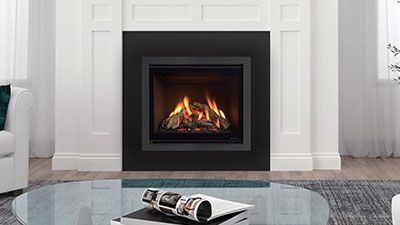 A Fireplace With A Picture On The Wall Above It — Mid Coast Mowers In Taree, NSW