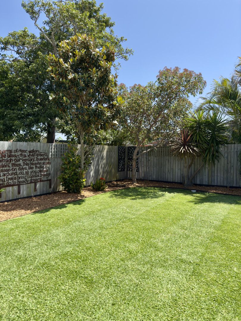 Lush Green Lawn in Front of a White House, Under a Cloudy Sky — Mow & Mulch Lawn & Garden Maintenance In Soldiers Point, NSW