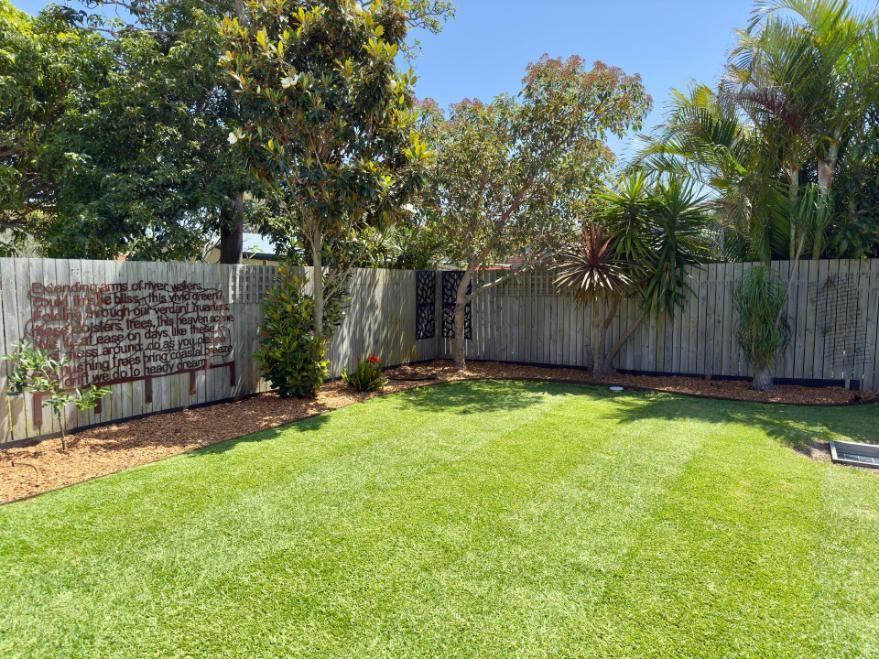 Lush Green Lawn in Front of a White House, Under a Cloudy Sky — Mow & Mulch Lawn & Garden Maintenance In Soldiers Point, NSW
