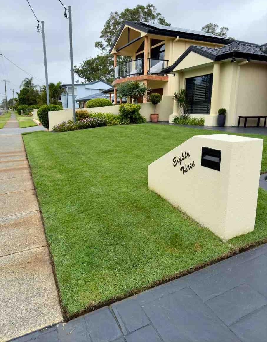 Well-maintained Lawn With Mailbox, Next to Sidewalk, in Front of a Two-story House  — Mow & Mulch Lawn & Garden Maintenance In Corlette, NSW