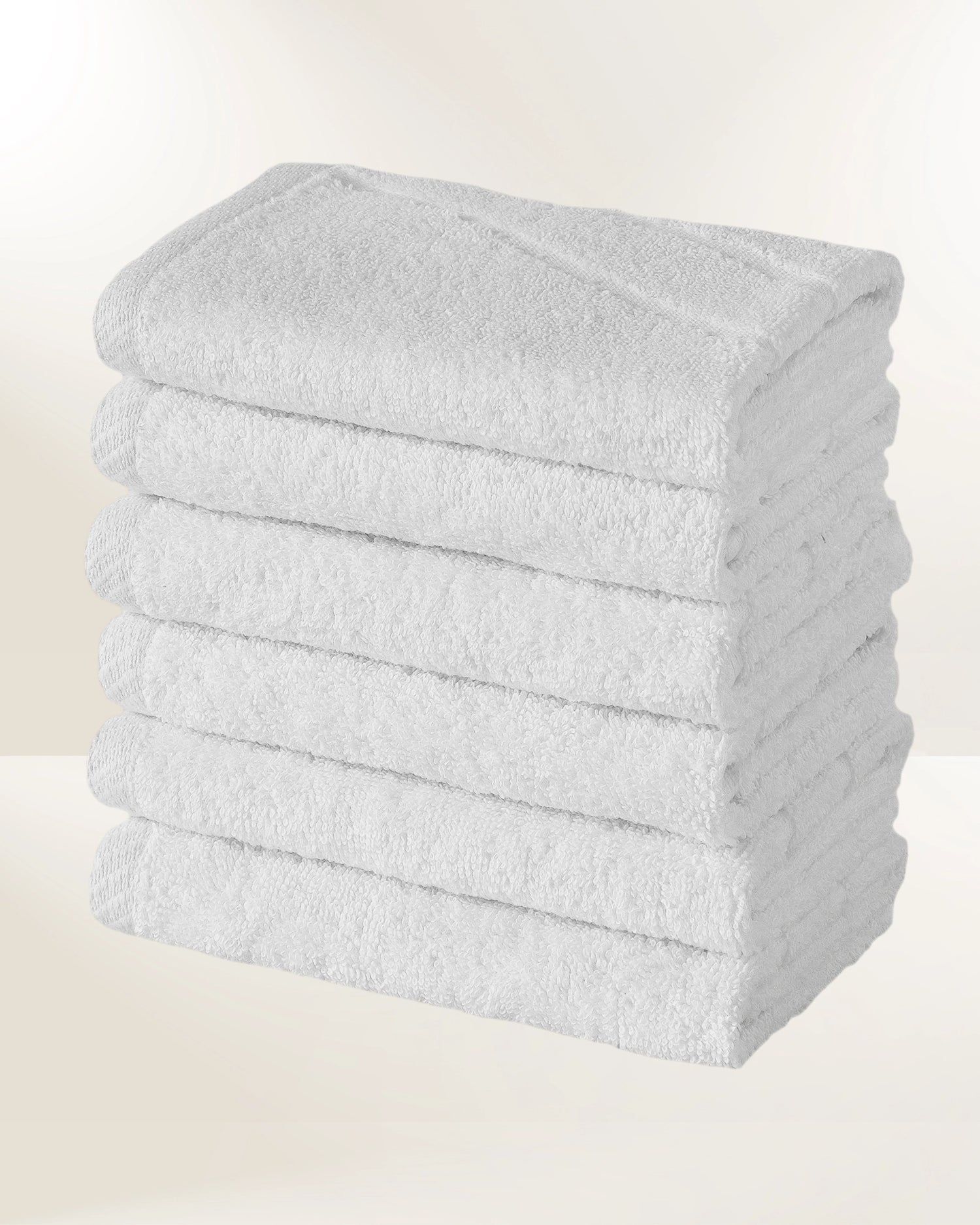 Stack of white folded towels on a light background