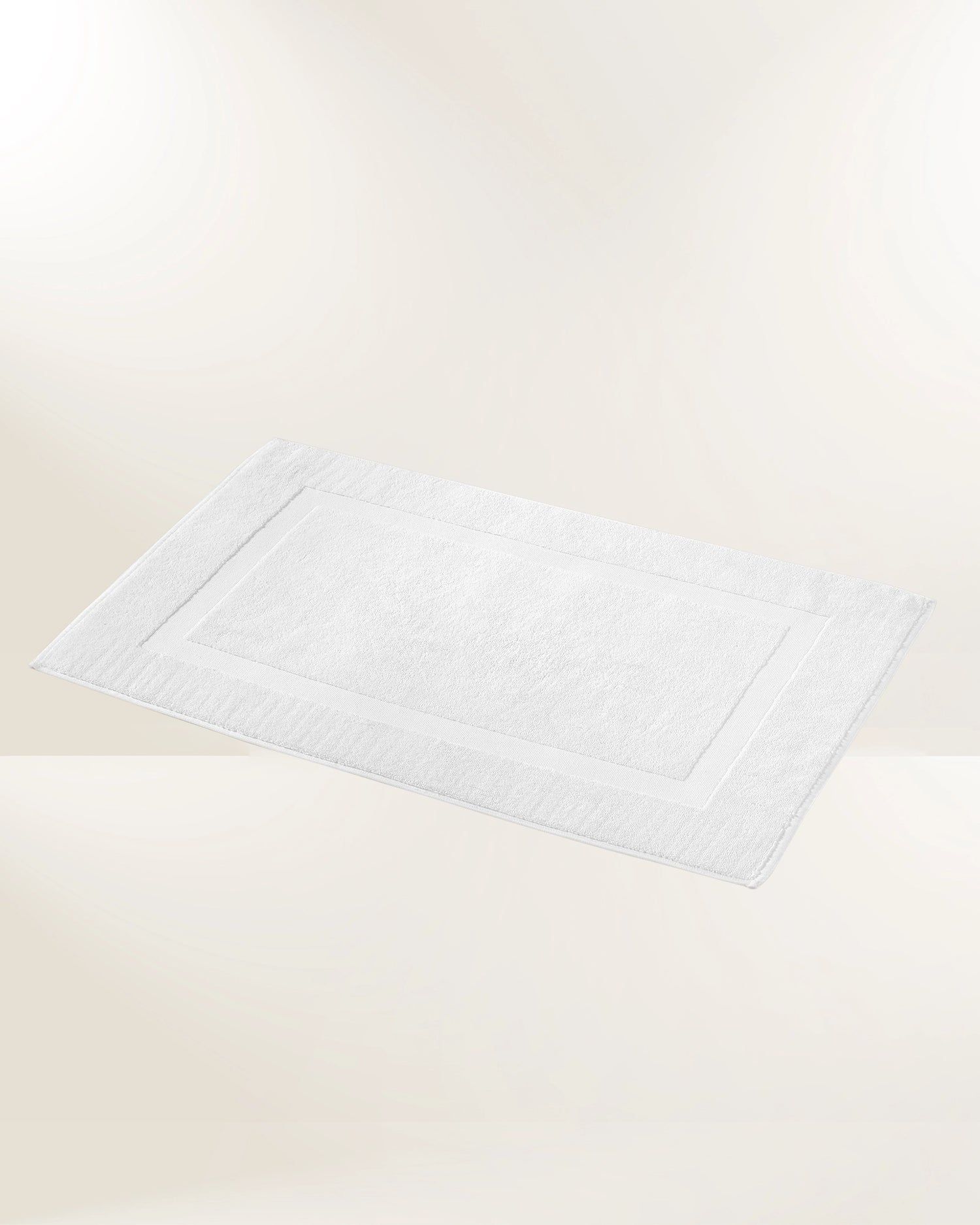 White rectangular textured mat on a light beige background, shown in perspective.