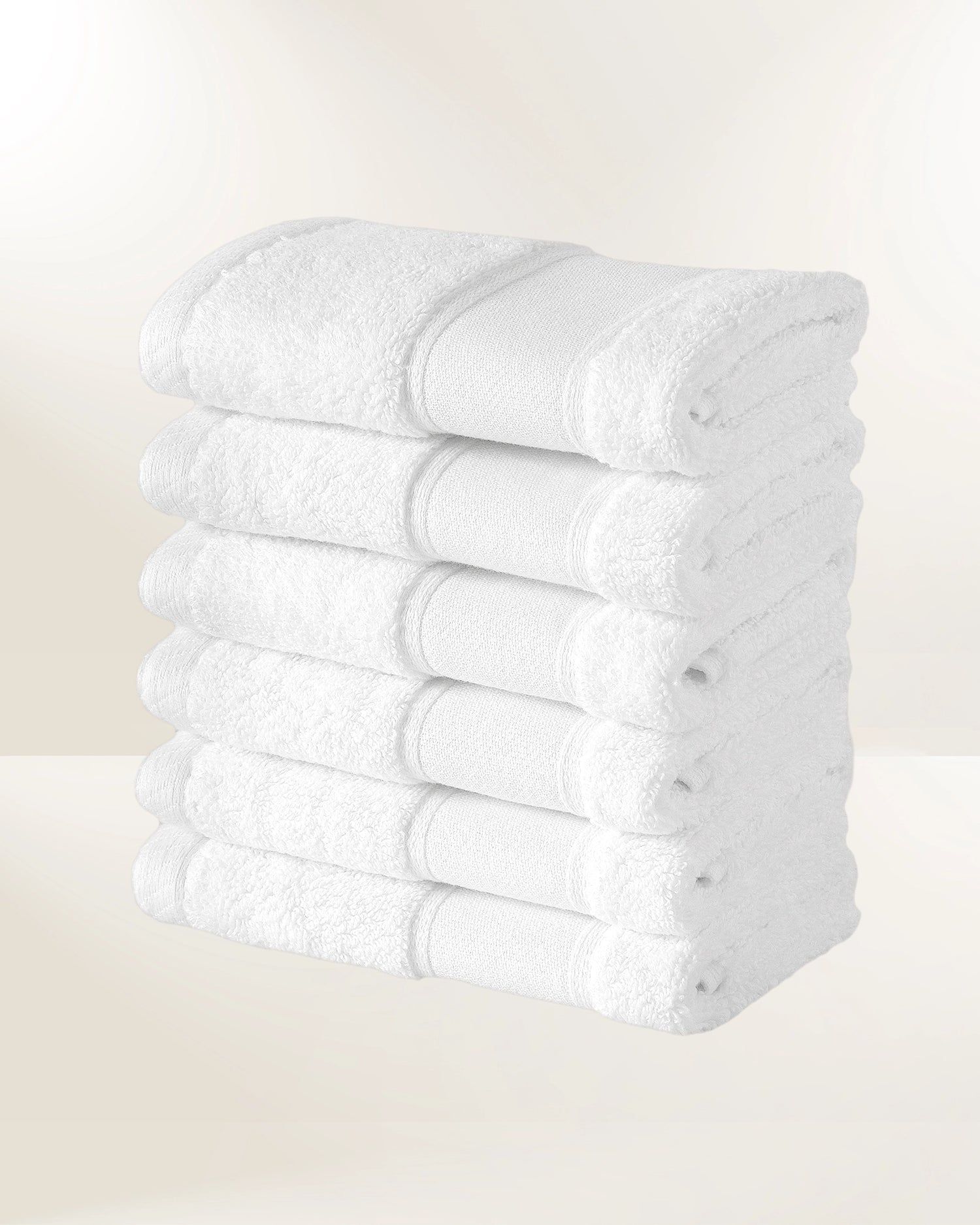 Stack of folded white towels on a light background