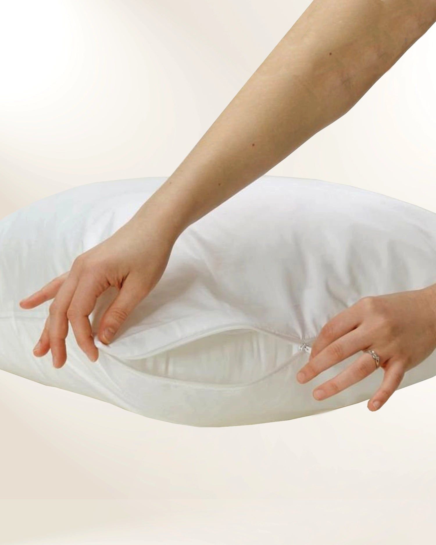 Hands adjusting a white pillow with a hidden zipper pocket
