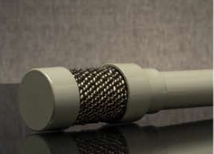 Close-up of a white handheld microphone with a metal mesh grille on a dark surface