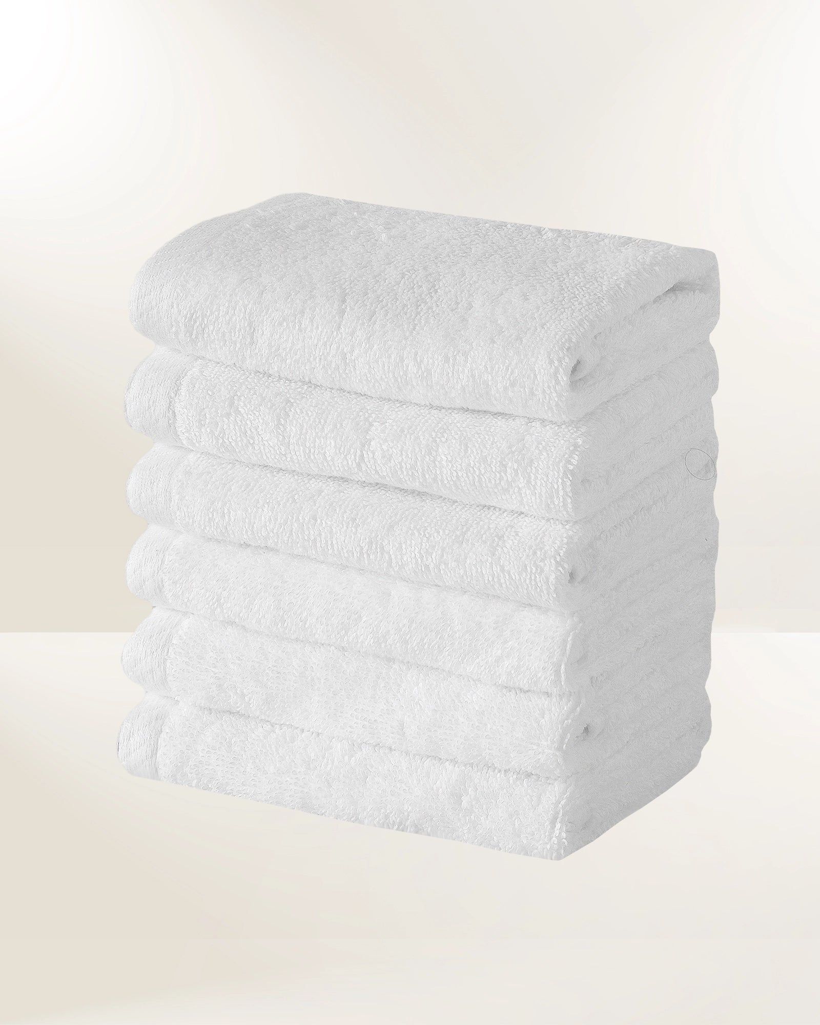 Stack of white folded towels on a light background
