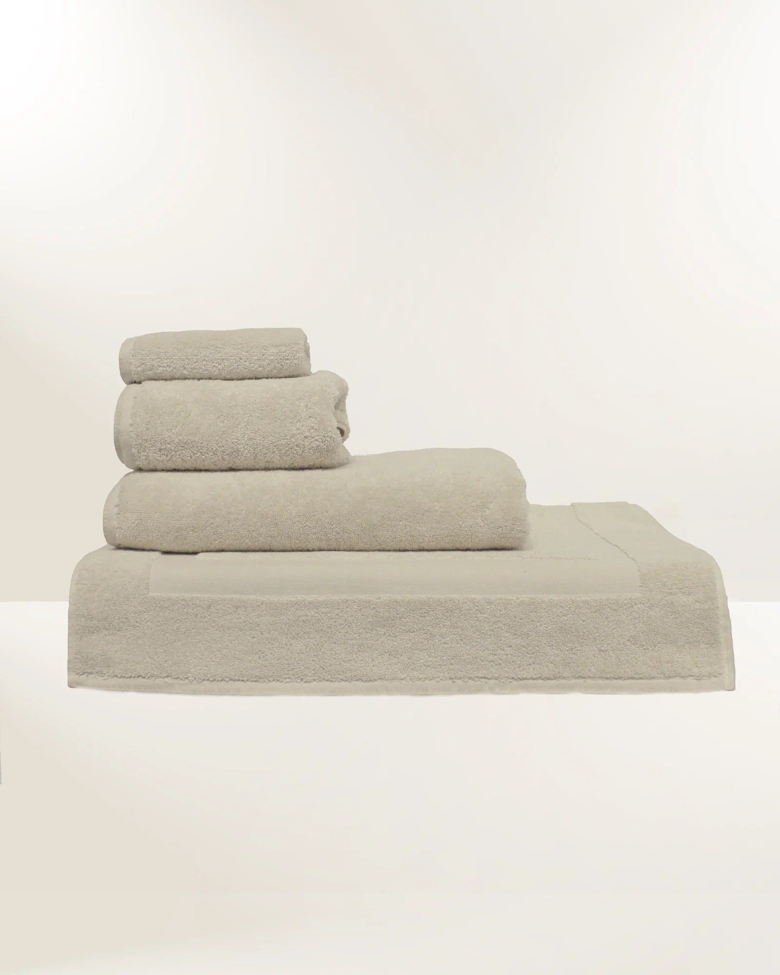 Stack of beige towels on a white background
