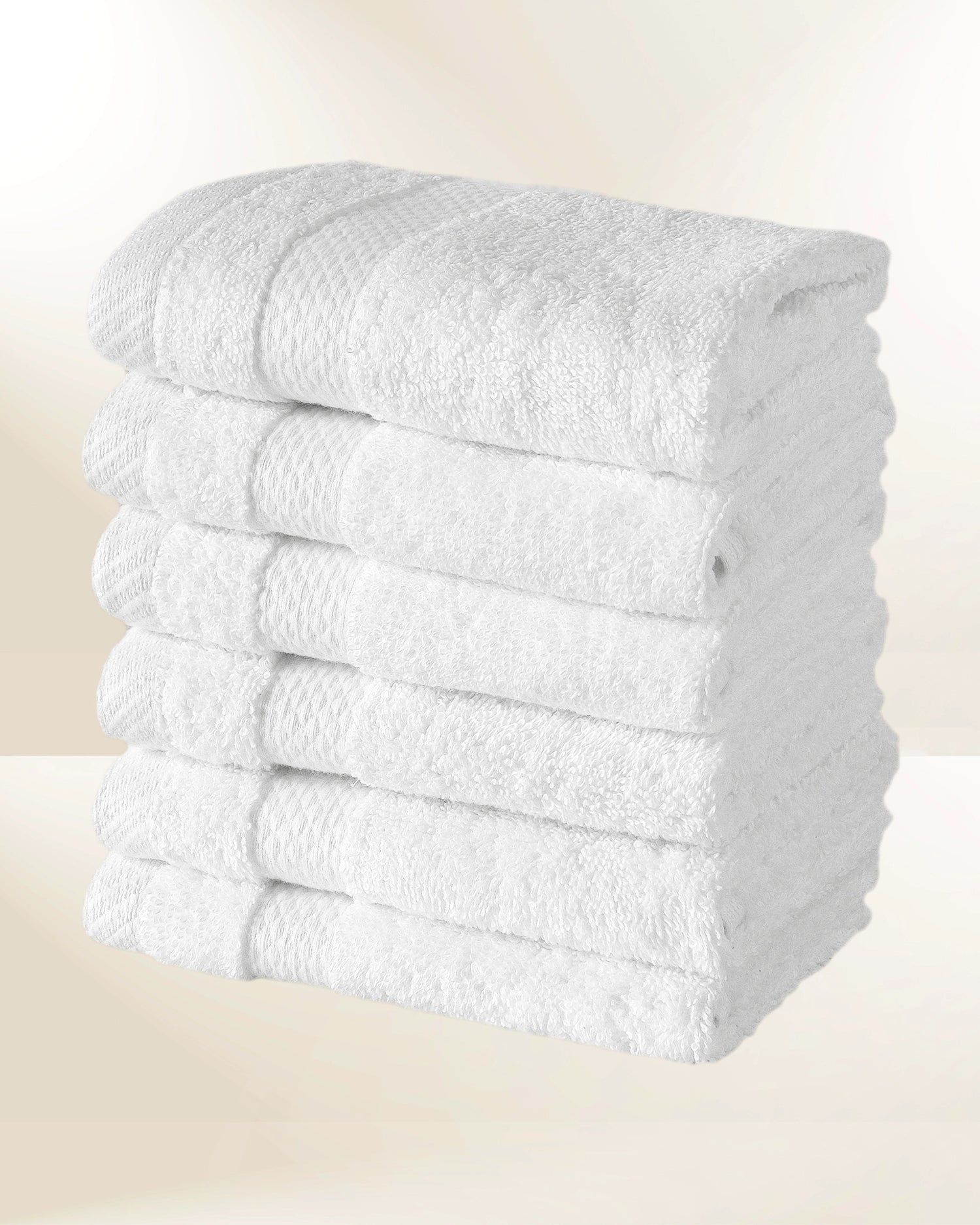 Stack of folded white towels on a light background