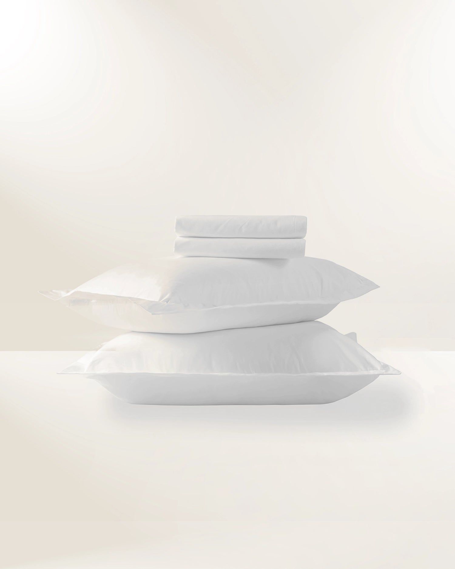 Stack of white folded towels on a light background