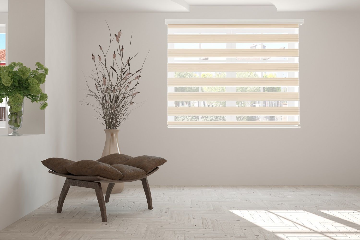 Minimalist living room with a low brown chair, vase of dried branches, and sunlight through striped blinds.