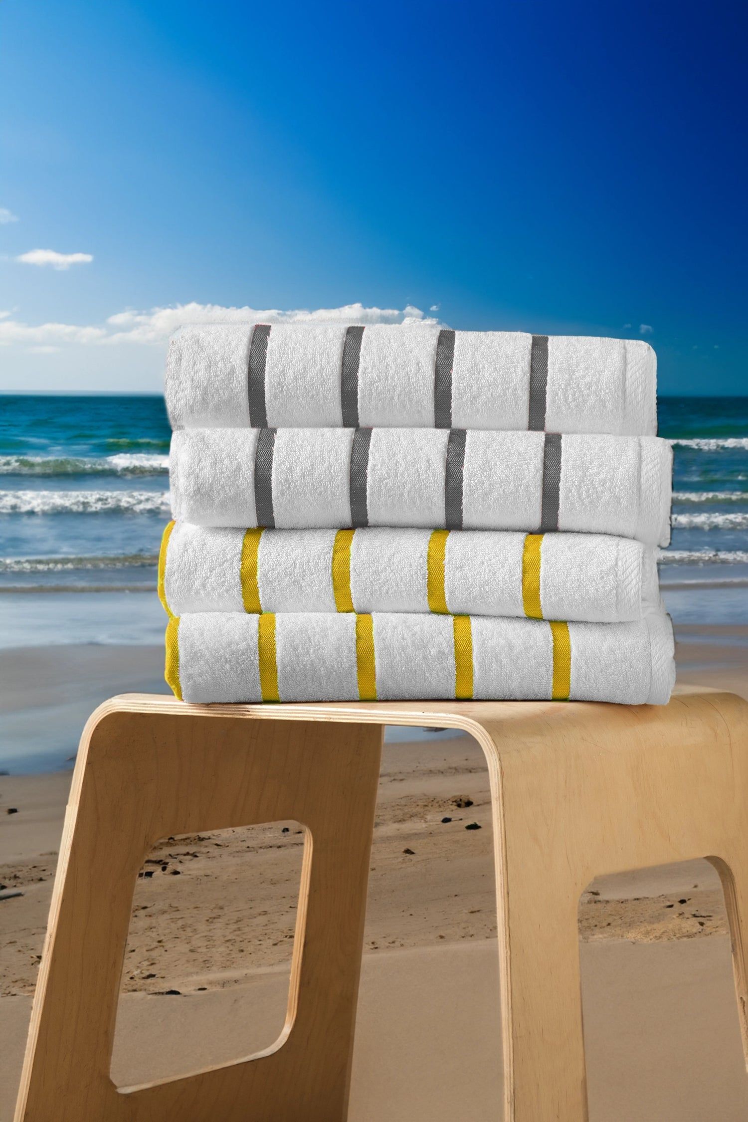 Stacked rolls of toilet paper on a stool at the beach with ocean and blue sky in the background