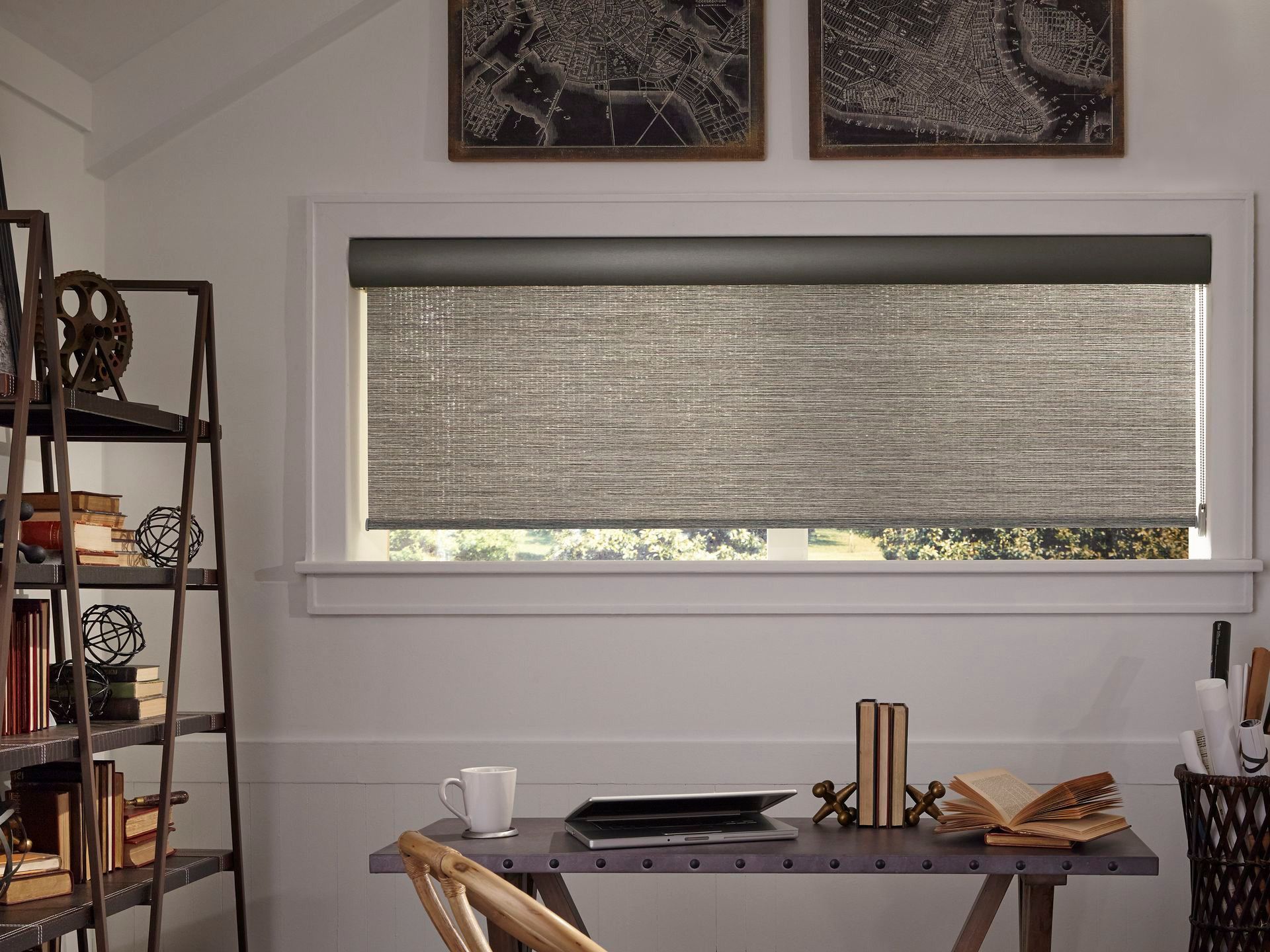 Dining table by a window with a closed blind, plates, cups, and bread in a modern room