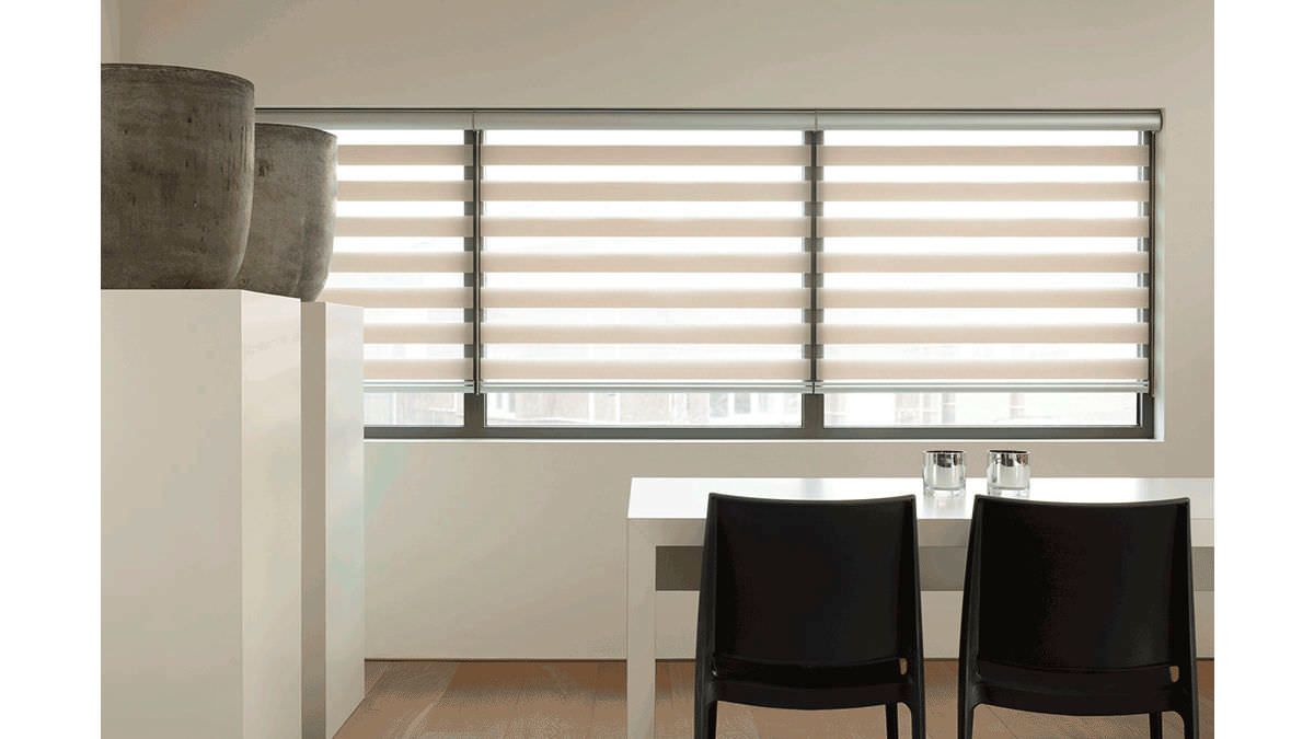 Modern dining area with a table, black chairs, and horizontal striped window blinds